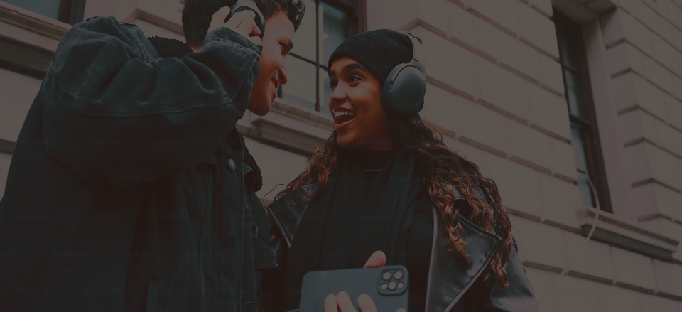 Man and woman wearing headphones and listening to music together